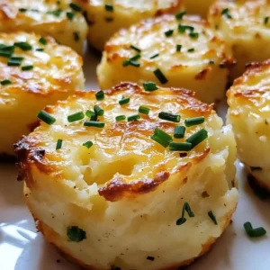 Golden brown Garlic Chive Mashed Potato Puffins topped with sour cream and fresh chives.