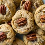A stack of Brown Butter Bourbon Pecan Chocolate Chunk Cookies with melted chocolate and pecans.