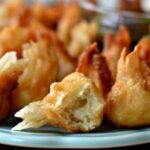 Golden brown Cream Cheese Wontons with Chicken and Pepper Jack served with dipping sauce