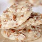 Golden pecan coconut praline cookies cooling on wax paper