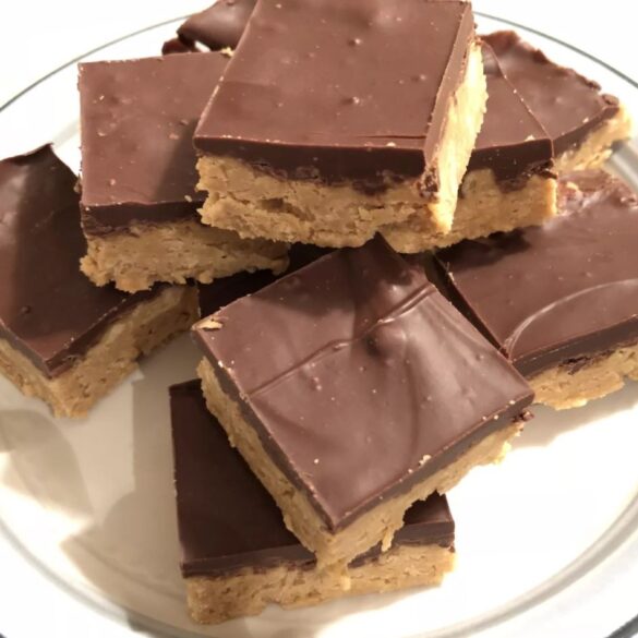A plate of Easy No Bake Peanut Butter Bars with a smooth chocolate topping.