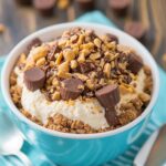 Slice of gooey peanut butter cup dump cake topped with chocolate chips