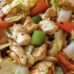 A plate of Chinese Chicken Cabbage Stir-Fry served over rice