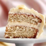 A slice of Banana Cake with Cream Cheese Frosting on a plate