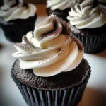 A plate of Black Velvet Marshmallow Cupcakes with fluffy frosting and gooey marshmallow filling.