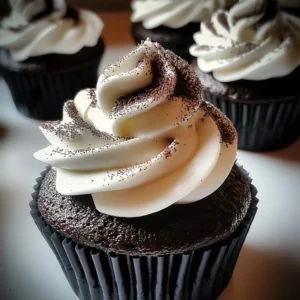 A plate of Black Velvet Marshmallow Cupcakes with fluffy frosting and gooey marshmallow filling.
