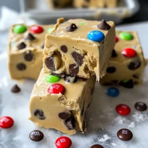A square of Chocolate Chip Cookie Dough Fudge with chocolate chips on top