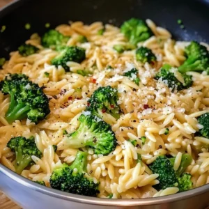 A bowl of Creamy Orzo with Parmesan Broccoli garnished with fresh Parmesan