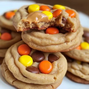 A stack of Mini Reese's Pieces Cookies with gooey peanut butter filling inside.