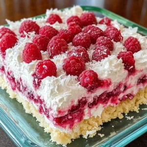 Raspberry Zinger Poke Cake topped with coconut and Cool Whip