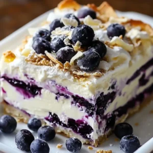 A slice of White Chocolate Blueberry Lasagna with creamy layers and fresh blueberries
