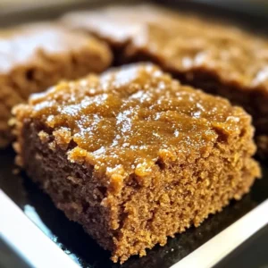 A slice of Amish Applesauce Cake on a plate with cinnamon dusting