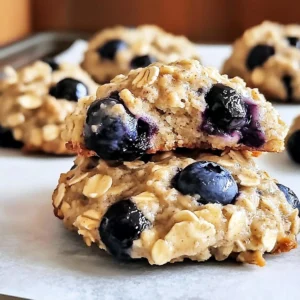 A plate of freshly baked Banana Blueberry Breakfast Cookies with a glass of milk
