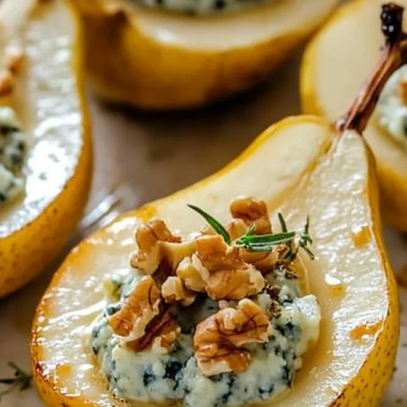 A beautifully plated Blue Cheese Stuffed Pear with honey drizzle and fresh thyme garnish.
