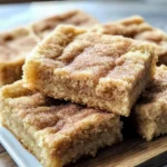 A plate of Chewy Snickerdoodle Cookie Bars with a golden cinnamon sugar topping