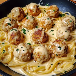 Plate of creamy Parmesan pasta with golden brown garlic butter chicken balls