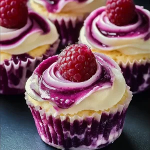 A close-up of Luscious Lemon Raspberry Swirl Cheesecake Cups in cupcake liners