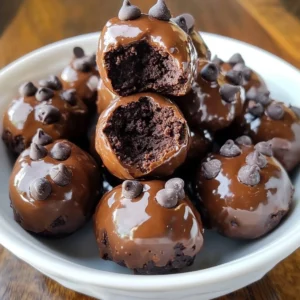 A plate of No-Bake Cottage Cheese Brownie Batter Protein Bites, dusted with cocoa powder