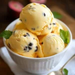 A bowl of Passion Fruit Ice Cream topped with fresh passion fruit pulp