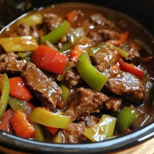 A bowl of Pepper Steak in a Crock Pot served over rice, garnished with fresh herbs