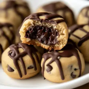 Freshly baked Reese’s peanut butter chocolate chip cookie bites on a cooling rack