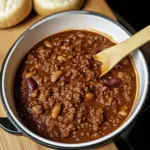 Bowl of Southern West Virginia Hot Dog Chili Sauce with Beans beside a loaded hot dog