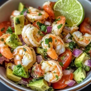 A bowl of Zesty Lime Shrimp and Avocado Salad garnished with fresh cilantro.