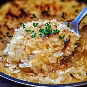 Bowl of French Onion Butter Rice garnished with parsley and melted cheese
