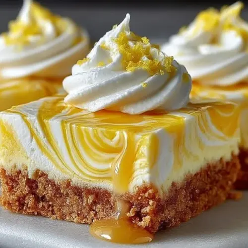 Elegant lemon marbled cheesecake bars served on a plate with a slice cut out