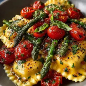 Plate of ravioli with tomatoes, asparagus, garlic, and herbs garnished beautifully