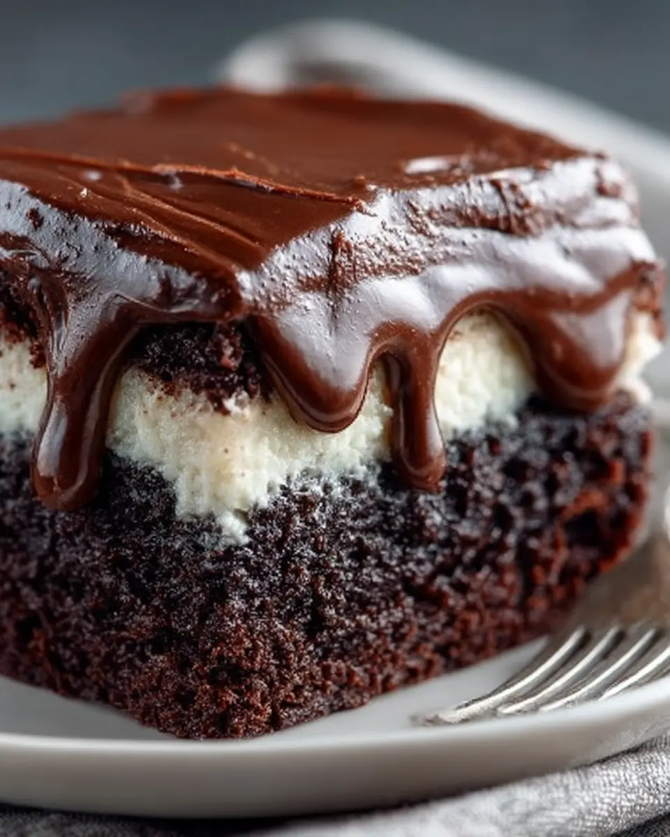 ing Dong Cake with creamy filling between chocolate layers and fudge frosting on a cake stand