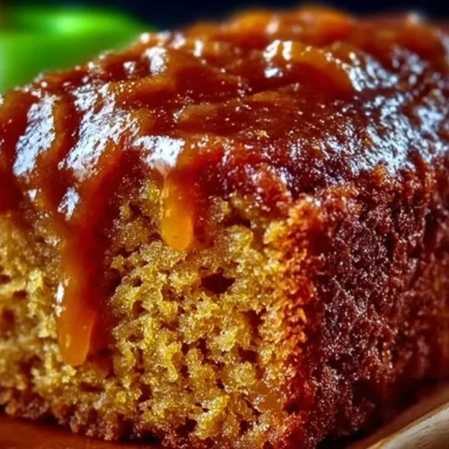 Delicious homemade apple sauce cake on a rustic wooden table