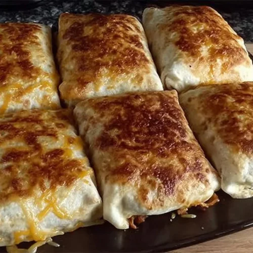 Golden baked chicken chimichangas served with salsa and guacamole.