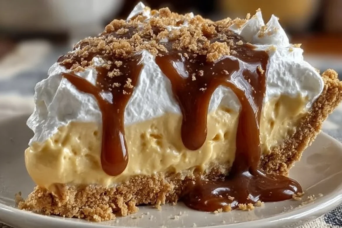 Delicious butterscotch pie topped with whipped cream and caramel drizzle