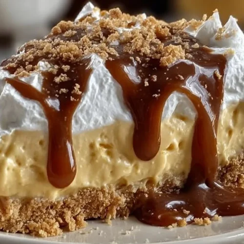Delicious butterscotch pie topped with whipped cream and caramel drizzle