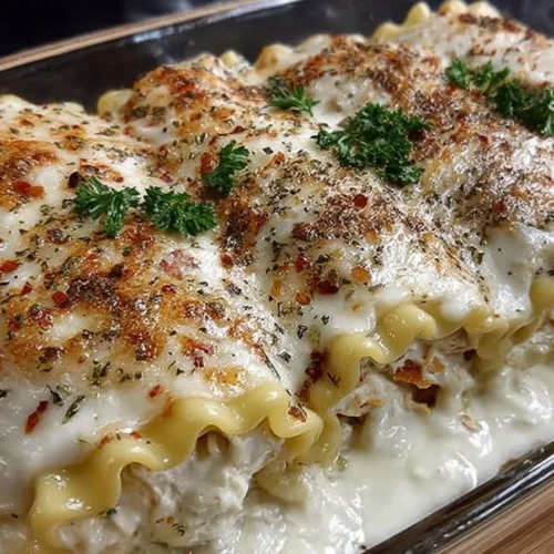 Delicious Chicken Alfredo Lasagna Roll served with herbs and cheese.