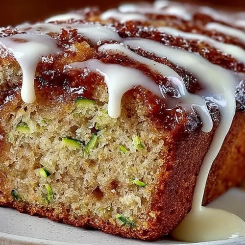 Freshly baked cinnamon roll zucchini bread with swirls and icing