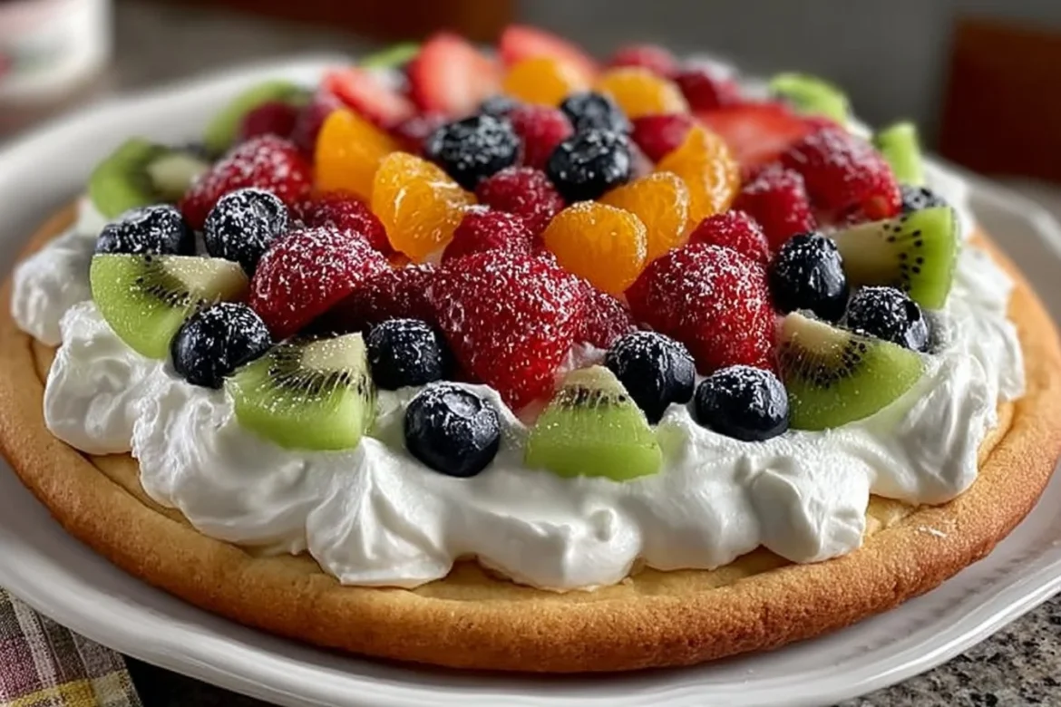Colorful fruit pizza topped with a variety of fresh fruits and a creamy base