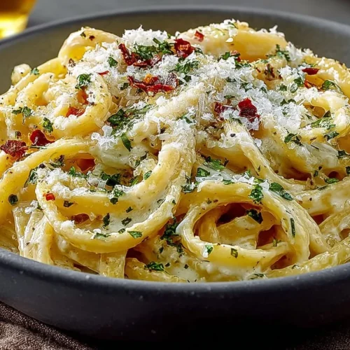Creamy garlic pasta dish garnished with parsley and served in a bowl