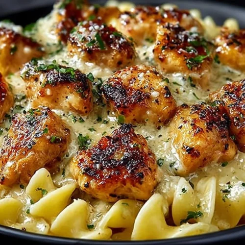 Delicious Garlic Butter Chicken Bites served with creamy Parmesan pasta.