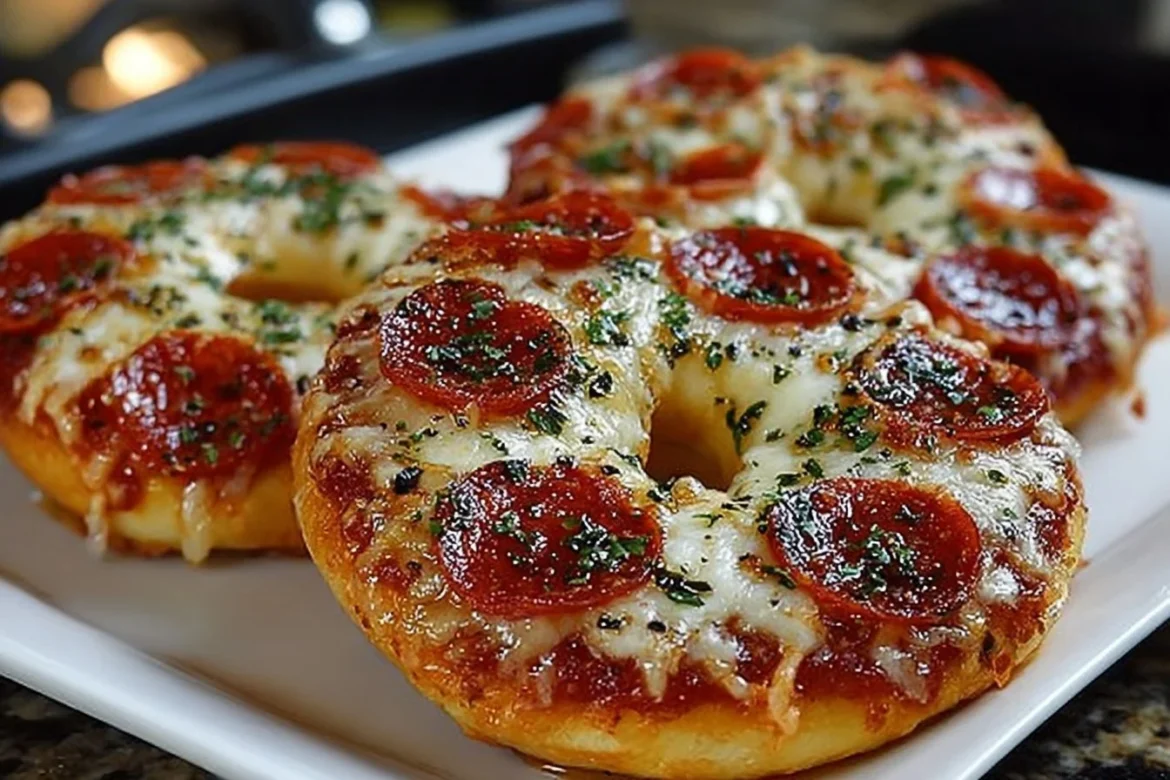 Homemade air fryer pizza bagels topped with cheese and pepperoni.