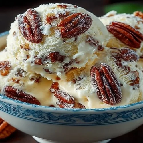 Bowl of creamy homemade butter pecan ice cream with pecans on top