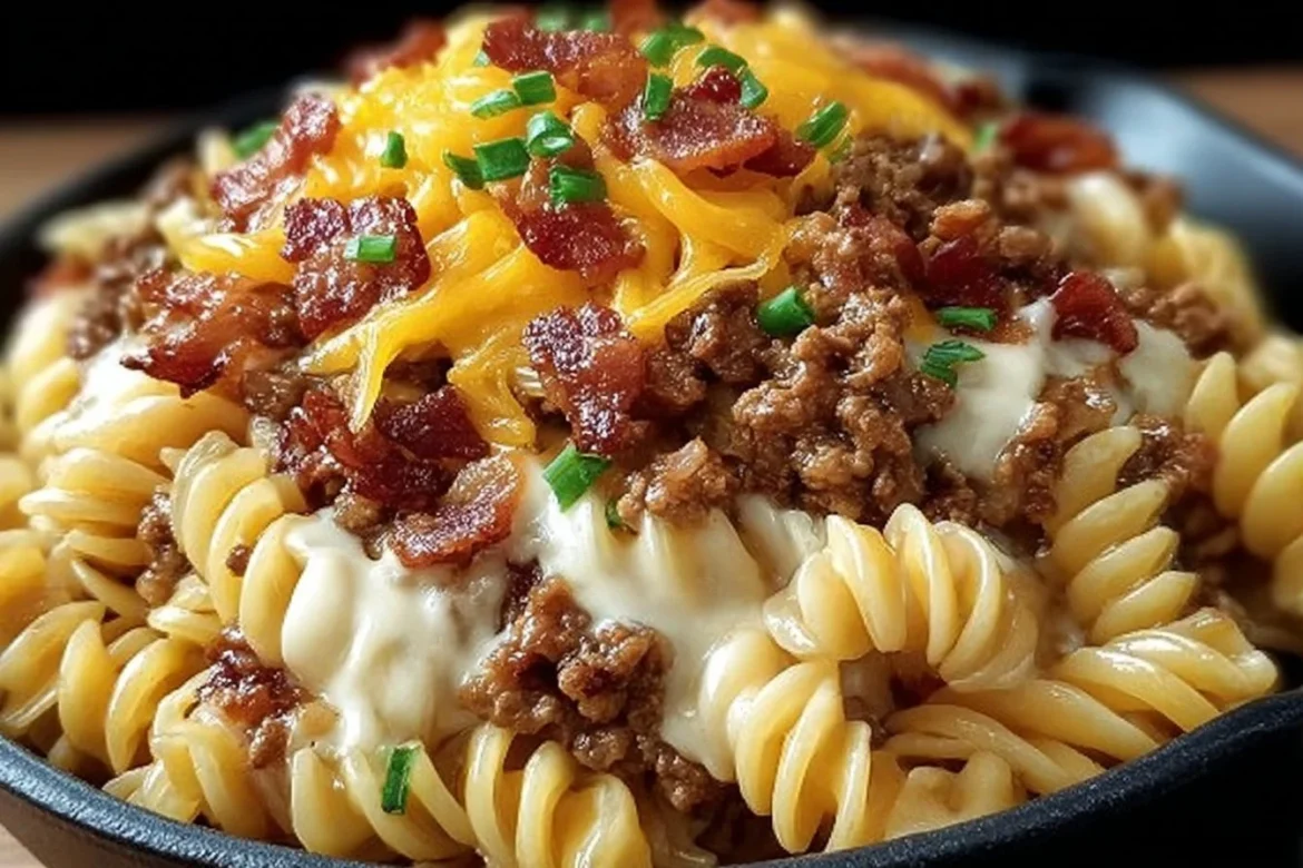 Loaded Bacon Cheeseburger Pasta Skillet in a pan with cheese and bacon