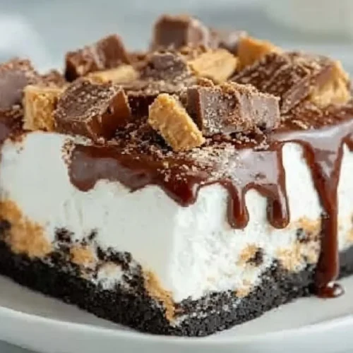 Peanut Butter Cup Icebox Cake topped with chocolate and peanut butter cups