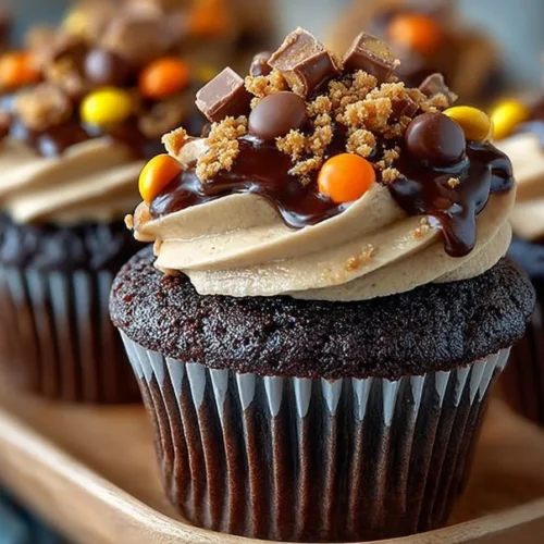 Delicious Reese's Chocolate Peanut Butter Cupcakes topped with Reese's pieces