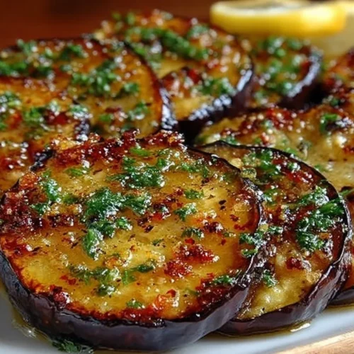 Delicious roasted eggplant dish garnished with herbs and spices
