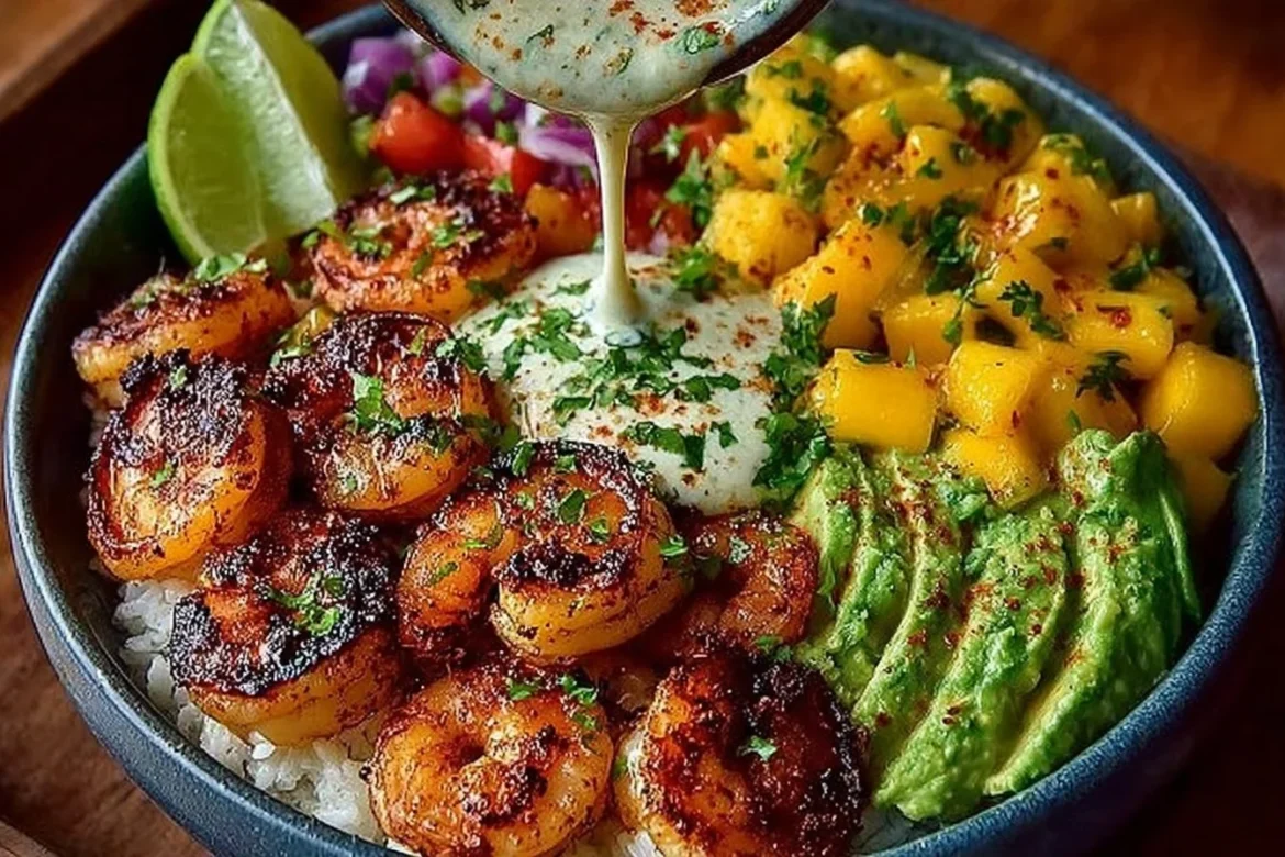 Colorful shrimp avocado bowls with mango salsa and lime-chili sauce