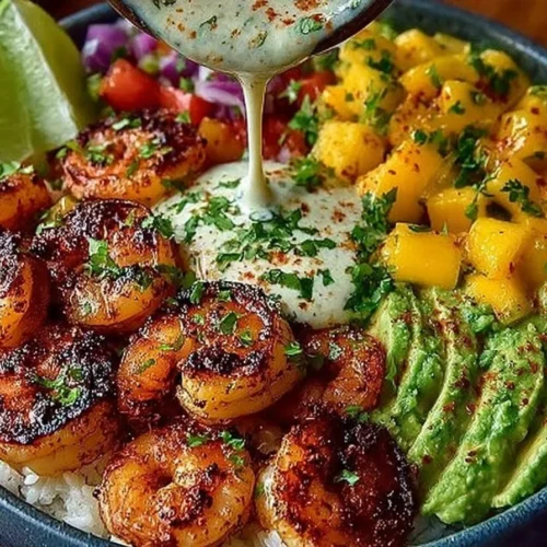 Colorful shrimp avocado bowls with mango salsa and lime-chili sauce