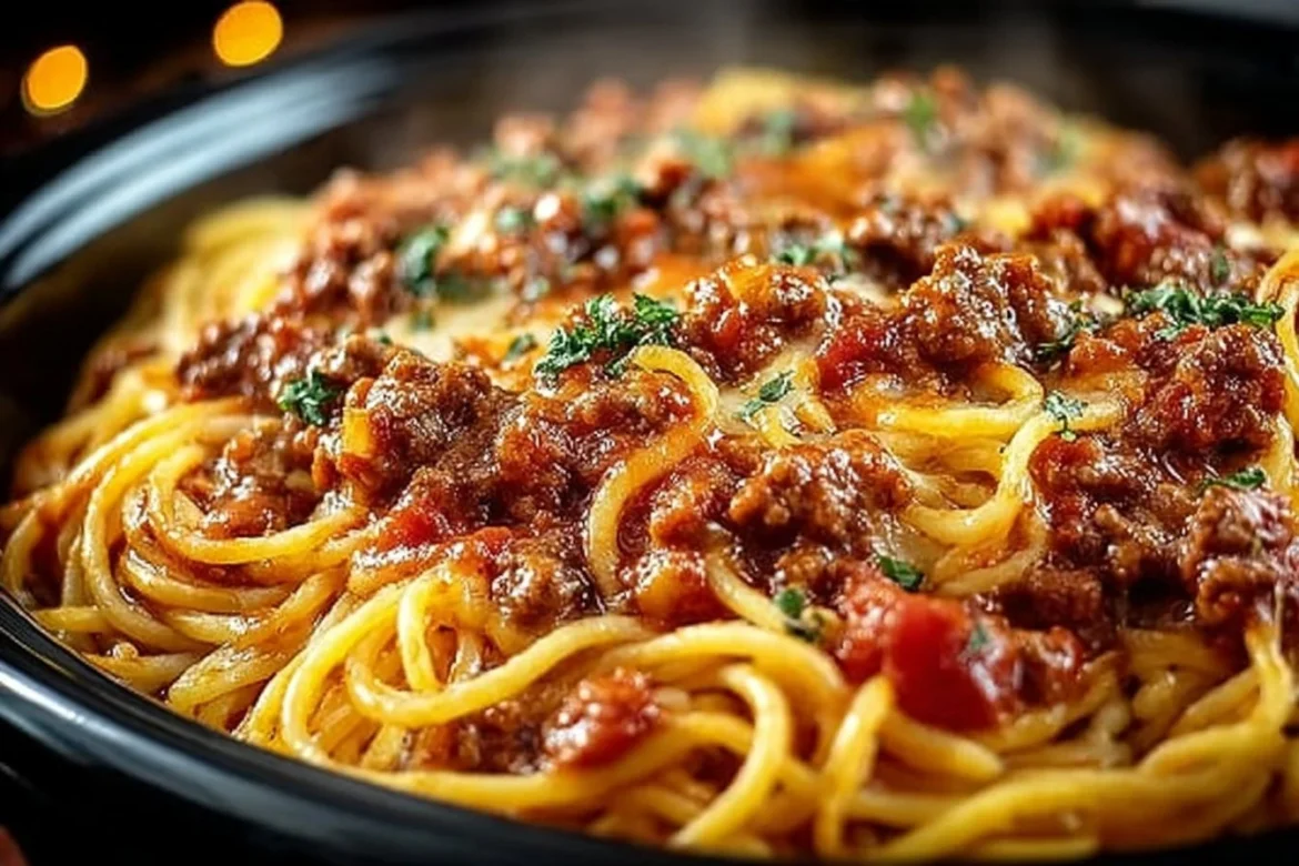 Delicious slow cooker spaghetti casserole served in a bowl with cheese topping