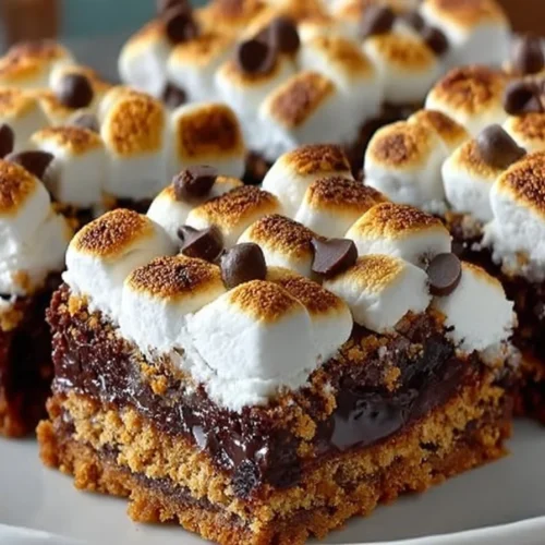 Delicious S'Mores Brownies topped with marshmallows and graham crackers